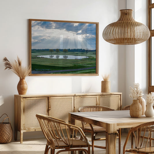 Dining room with wooden furniture, framed landscape painting, and wicker pendant light.